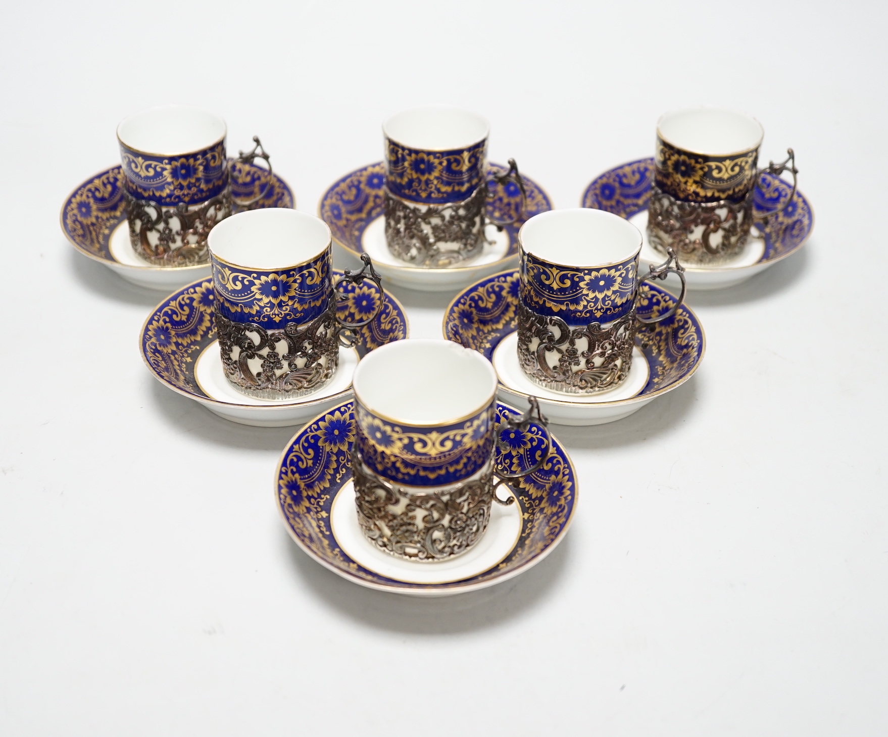 A set of six silver jacketed porcelain cups and saucers